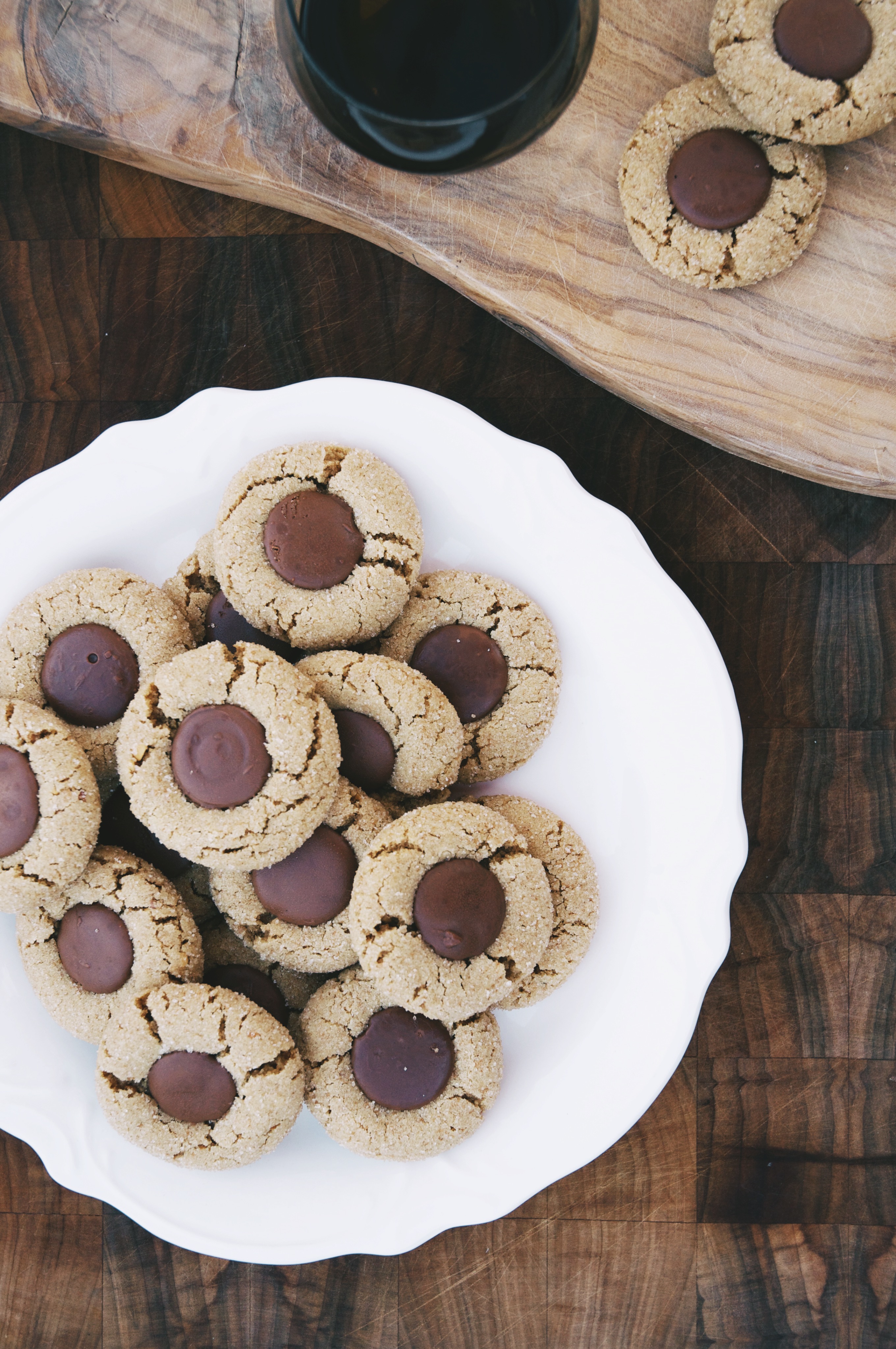 sparkling almond butter and chocolate cookies on a plate and on a cutting board
